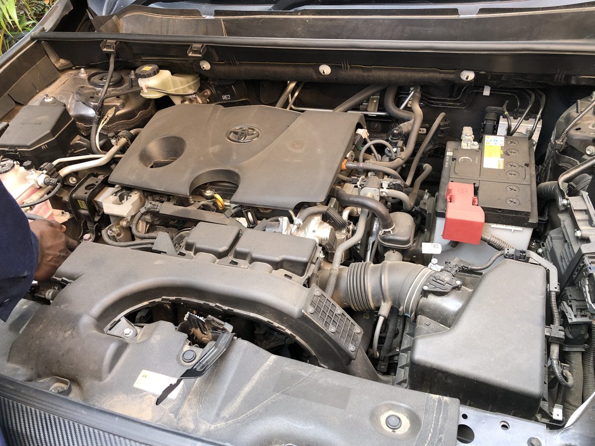 Toyota engine bay covered in dust before steam cleaning