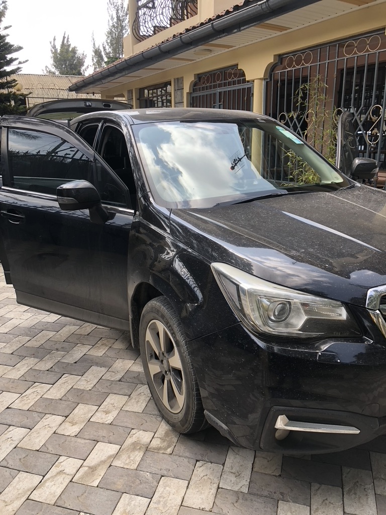 Black Subaru Forester covered in dust before detailing